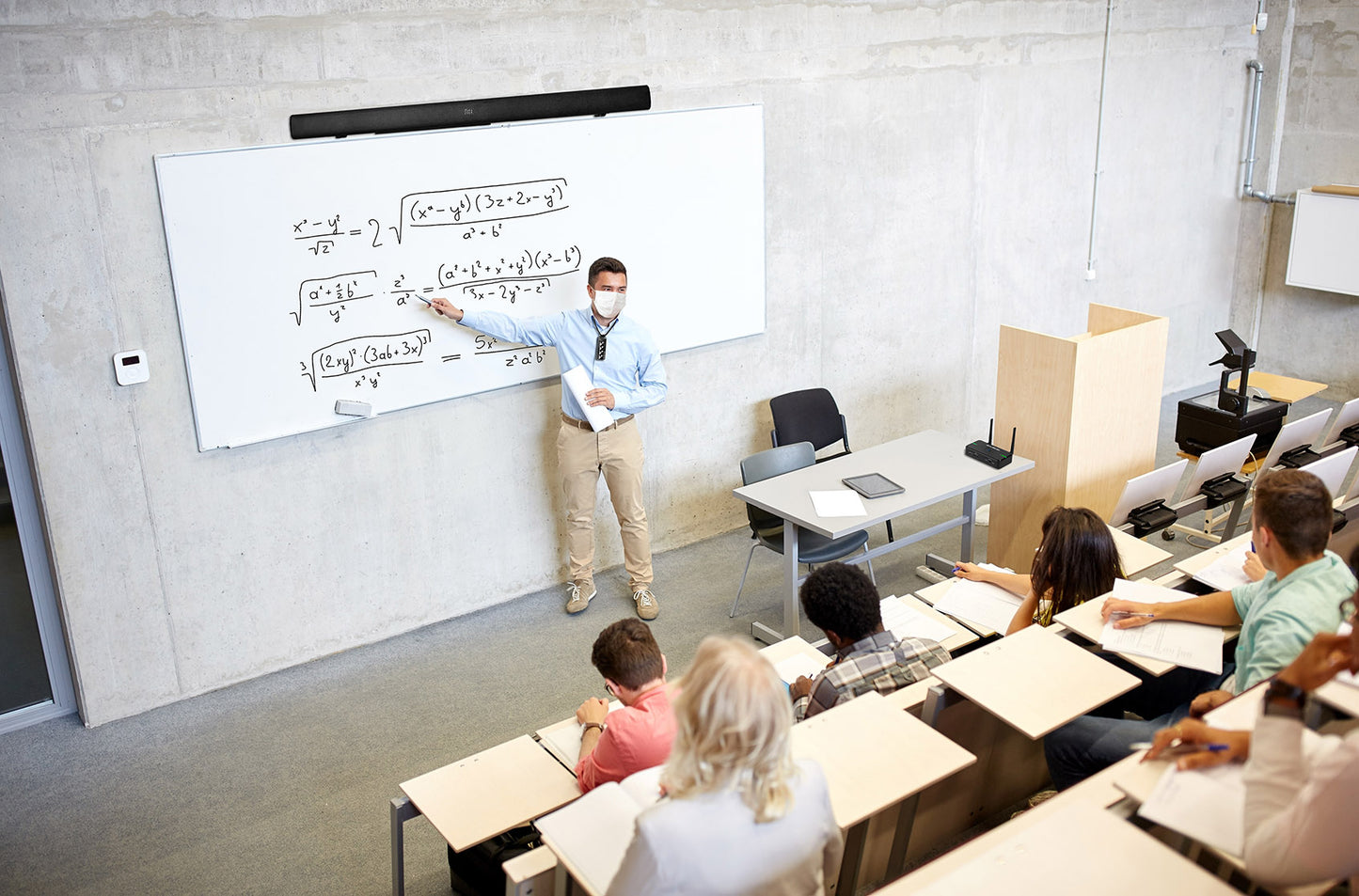 Teacher using the wireless microphone in a large classroom
